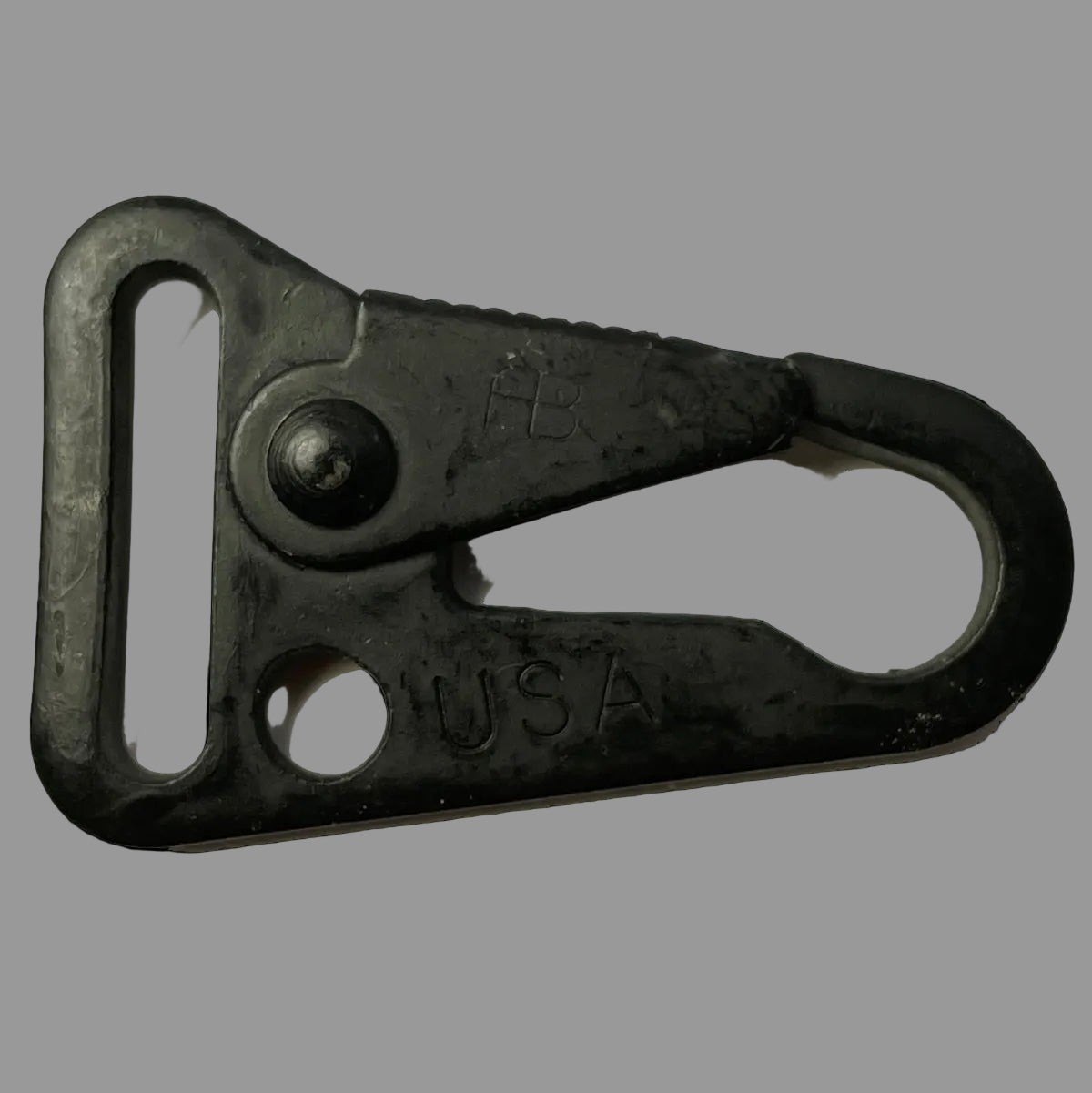 Black metal clash hook with 'USA' engraving on a black background